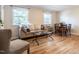 Inviting living room featuring hardwood floors, neutral furnishings, and large windows for ample natural light at 979 St Marys St # G6, Raleigh, NC 27605