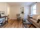 Charming living area featuring hardwood floors, built-in shelving, and comfortable seating near a bright window at 979 St Marys St # G6, Raleigh, NC 27605