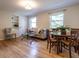 Bright living and dining area with hardwood floors, comfortable seating, and ample natural light from large windows at 979 St Marys St # G6, Raleigh, NC 27605