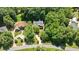 Aerial view of the home site surrounded by lush trees and landscaping at 1008 Old Meetinghouse Way, Raleigh, NC 27615