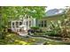 Exterior view of backyard featuring a patio with dining set and outdoor grill, plus a landscaped water feature at 1008 Old Meetinghouse Way, Raleigh, NC 27615
