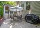 Outdoor patio space with grill, a dining set, and umbrella perfect for entertaining at 1008 Old Meetinghouse Way, Raleigh, NC 27615