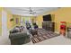 Spacious finished basement features a large tv, seating, bar area, and zebra-print rug at 1008 Old Meetinghouse Way, Raleigh, NC 27615