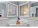 Elegant bathroom featuring a large soaking tub with custom stained glass windows at 1008 Old Meetinghouse Way, Raleigh, NC 27615
