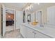 Bathroom with double sinks, vanity, large mirrors, tile floors, and great natural light at 1008 Old Meetinghouse Way, Raleigh, NC 27615