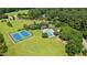 Aerial view of community amenities, including tennis courts and a swimming pool, surrounded by green space at 1008 Old Meetinghouse Way, Raleigh, NC 27615