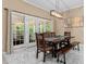 Dining room featuring a wooden table and chairs with a view through glass doors to a patio at 1008 Old Meetinghouse Way, Raleigh, NC 27615