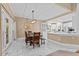 Dining area with marble flooring connecting the kitchen and outdoors through glass doors at 1008 Old Meetinghouse Way, Raleigh, NC 27615
