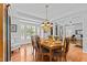 Elegant dining room with hardwood floors, a large window, and a decorative chandelier at 1008 Old Meetinghouse Way, Raleigh, NC 27615