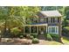 Beautiful brick home featuring a lush front yard and welcoming front porch at 1008 Old Meetinghouse Way, Raleigh, NC 27615