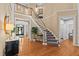 Welcoming foyer with hardwood floors, staircase, and views to the front door at 1008 Old Meetinghouse Way, Raleigh, NC 27615