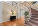 Grand foyer with hardwood floors, curved staircase, and elegant decor at 1008 Old Meetinghouse Way, Raleigh, NC 27615