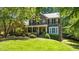 Beautiful brick home featuring a lush front yard and welcoming front porch at 1008 Old Meetinghouse Way, Raleigh, NC 27615