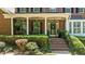 Inviting front porch with elegant columns, hanging plants, and a decorative front door at 1008 Old Meetinghouse Way, Raleigh, NC 27615