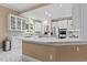 Well-lit kitchen featuring white cabinets, stainless steel appliances, and marble floors at 1008 Old Meetinghouse Way, Raleigh, NC 27615