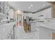 Spacious open kitchen with white cabinets, stainless steel appliances, and a breakfast bar at 1008 Old Meetinghouse Way, Raleigh, NC 27615