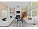 Bright living room with fireplace, high ceilings, and large windows at 1008 Old Meetinghouse Way, Raleigh, NC 27615