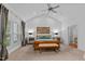 Vaulted main bedroom with neutral carpeting, ceiling fan, and shutters at 1008 Old Meetinghouse Way, Raleigh, NC 27615