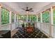 Relaxing screened porch with a ceiling fan, string lights, and views of the backyard at 1008 Old Meetinghouse Way, Raleigh, NC 27615