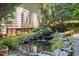 Close-up of a landscaped water feature in the backyard, featuring rocks, plants, and a small waterfall at 1008 Old Meetinghouse Way, Raleigh, NC 27615