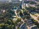 Community aerial view featuring pool, tennis courts, and tree-lined streets at 1009 Porchside Dr, Apex, NC 27502