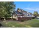 Landscaped backyard with fencing, grassy area, and mature trees offering shade at 1009 Porchside Dr, Apex, NC 27502