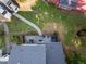 Aerial view of the home's fenced backyard with patio, walkway, and plantings at 1009 Porchside Dr, Apex, NC 27502