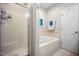 Bright bathroom featuring a tiled shower, jacuzzi tub, updated hardware and decor at 1009 Porchside Dr, Apex, NC 27502