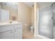 Bright bathroom features a white vanity, mirror and glass door shower at 1009 Porchside Dr, Apex, NC 27502
