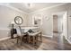 Elegant dining room with a table, upholstered chairs, bench, and a view to the kitchen at 1009 Porchside Dr, Apex, NC 27502