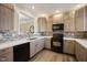 Well-lit kitchen with modern appliances, light wood cabinets, and a decorative backsplash at 1009 Porchside Dr, Apex, NC 27502