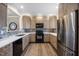 Modern kitchen with stainless steel appliances, granite countertops, and stylish cabinetry at 1009 Porchside Dr, Apex, NC 27502