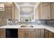 Modern kitchen with granite countertops, stainless steel sink, and an open view to the living room at 1009 Porchside Dr, Apex, NC 27502