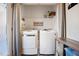 Bright laundry room featuring new washer and dryer, overhead shelving, and custom decor at 1009 Porchside Dr, Apex, NC 27502