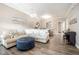 Inviting living room featuring a comfortable sectional sofa and an ottoman, perfect for relaxing at 1009 Porchside Dr, Apex, NC 27502