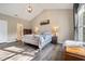 Sun-filled main bedroom with vaulted ceiling, ensuite bath, and wood-look flooring at 1009 Porchside Dr, Apex, NC 27502