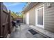 Private outdoor patio area with seating, a grill, and access to the home at 1009 Porchside Dr, Apex, NC 27502