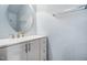 Tastefully designed powder room with updated vanity, sink, hardware and oval mirror at 1009 Porchside Dr, Apex, NC 27502
