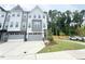 Modern townhome with a two-car garage, neutral color scheme and well-maintained landscaping at 1015 Regalia Rd # 27, Durham, NC 27713