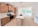 This open-concept kitchen boasts stainless appliances, light wood cabinets, and a spacious island at 1015 Regalia Rd # 27, Durham, NC 27713