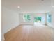 This open-concept living room is light and bright with hardwood floors and access to the deck at 1015 Regalia Rd # 27, Durham, NC 27713