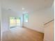 Living room with wood floors, a sliding glass door, and abundant natural light at 1015 Regalia Rd # 27, Durham, NC 27713