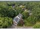 Aerial view of brick home surrounded by mature trees and verdant landscaping providing shade and privacy at 102 Alidade Ct, Cary, NC 27513