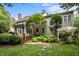 Green backyard with mature trees, a pergola, a wooden deck, and a well-maintained lawn, perfect for outdoor enjoyment at 102 Alidade Ct, Cary, NC 27513