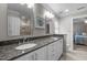 Elegant bathroom featuring double sinks, granite countertops, and a framed mirror with shower view at 102 Alidade Ct, Cary, NC 27513