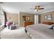 Spacious main bedroom with a ceiling fan and seating area with a floral arm chair at 102 Alidade Ct, Cary, NC 27513