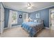 Inviting bedroom with blue walls, light-filled windows, and comfortable furnishings with a ceiling fan at 102 Alidade Ct, Cary, NC 27513