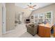 Versatile bonus room with natural light and a comfortable seating area with a ceiling fan at 102 Alidade Ct, Cary, NC 27513
