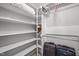 Spacious walk-in closet featuring custom shelving and ample storage for organization at 102 Alidade Ct, Cary, NC 27513