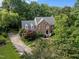 Beautiful brick home featuring a manicured front lawn and mature trees providing ample shade and privacy at 102 Alidade Ct, Cary, NC 27513